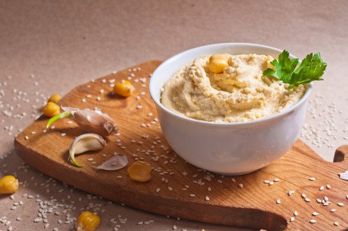 Delicious hummus on the table with sesame seeds